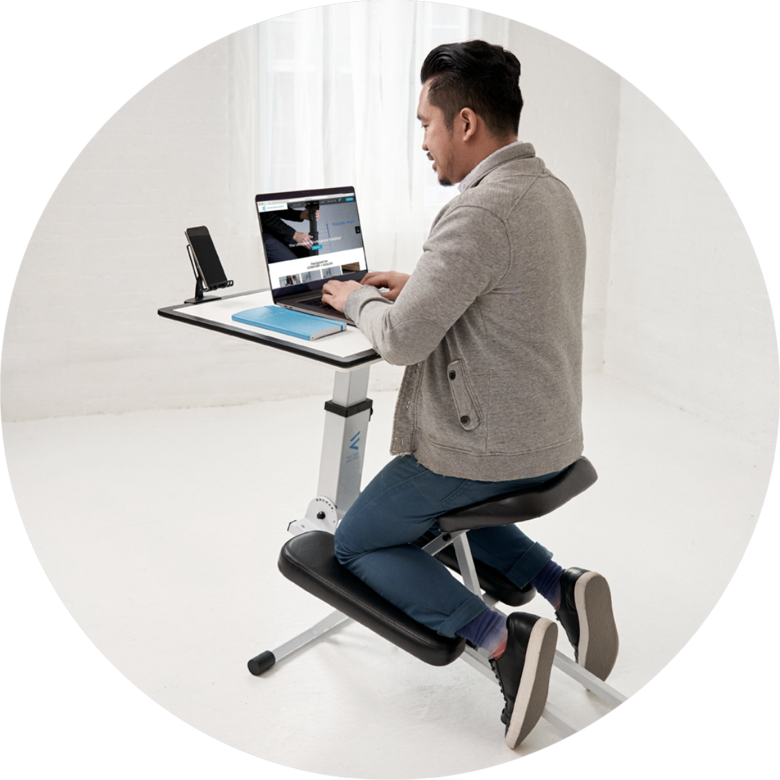 Man using the edge desk ergonomic kneeling desk as an adjustable workstation